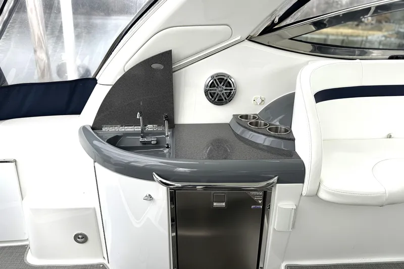 Slide: The Image of 2016 Formula 34 Performance Cruiser interior with sink, cup holders, and seating. - 8