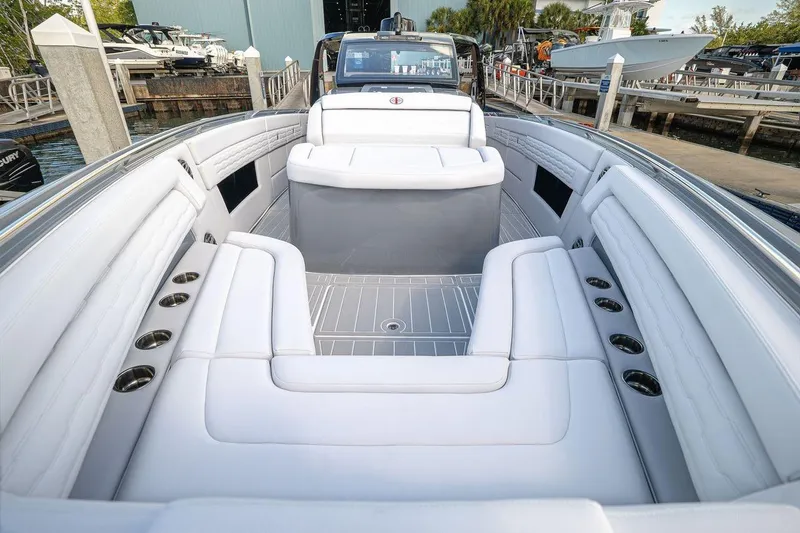 Slide: The Image of 2026 Cigarette 42' Auroris luxury boat interior with white seating and cup holders. - 9