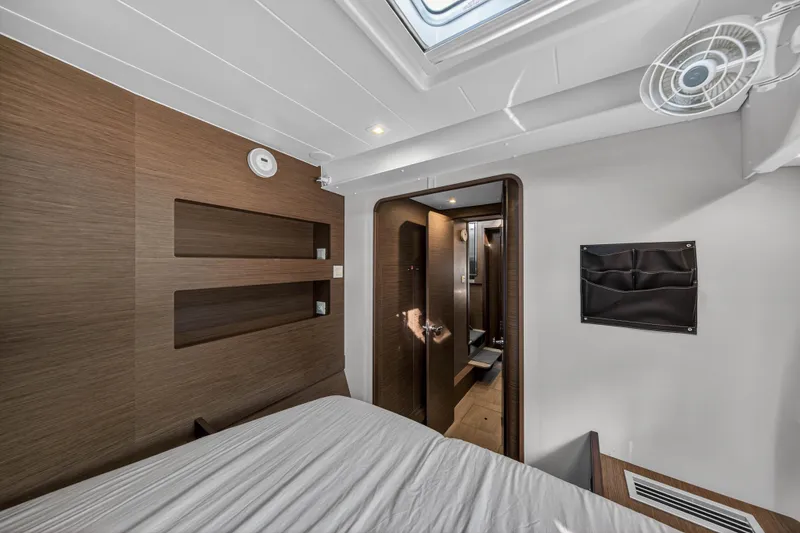 Slide: The Image of Interior of 2019 Lagoon 42 yacht cabin with modern wood finish and skylight. - 101