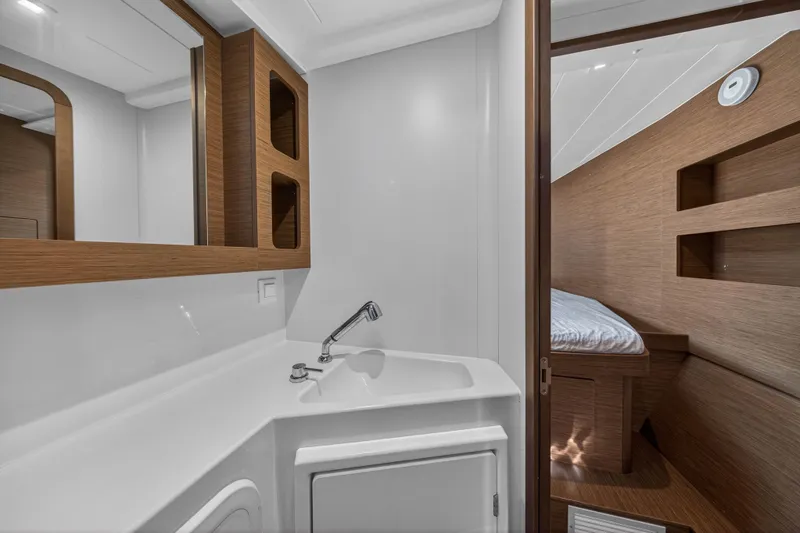 Slide: The Image of Interior of 2019 Lagoon 42 yacht featuring a compact bathroom and cozy cabin. - 103