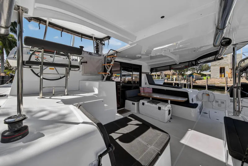 Slide: The Image of Spacious 2019 Lagoon 42 catamaran cockpit with seating and helm station. - 12