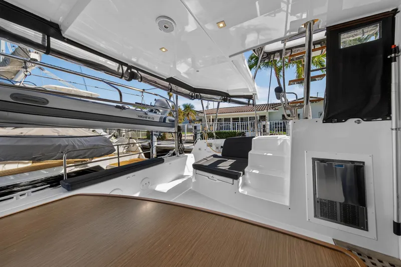 Slide: The Image of 2019 Lagoon 42 yacht interior with seating, steps, and outdoor view. - 19