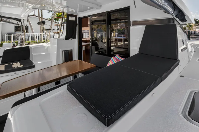 Slide: The Image of 2019 Lagoon 42 yacht interior with sleek seating and wooden table. - 23