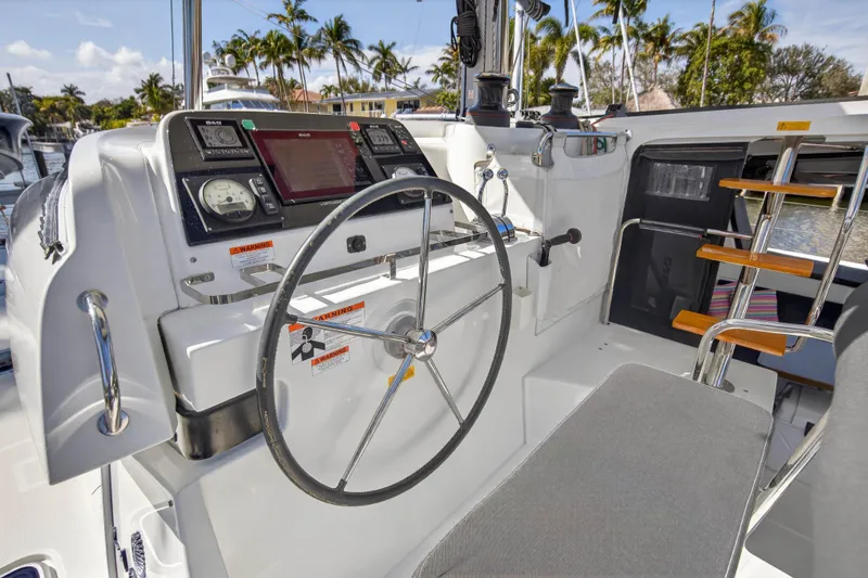 Slide: The Image of Helm of 2019 Lagoon 42 catamaran with navigation controls and steering wheel. - 29