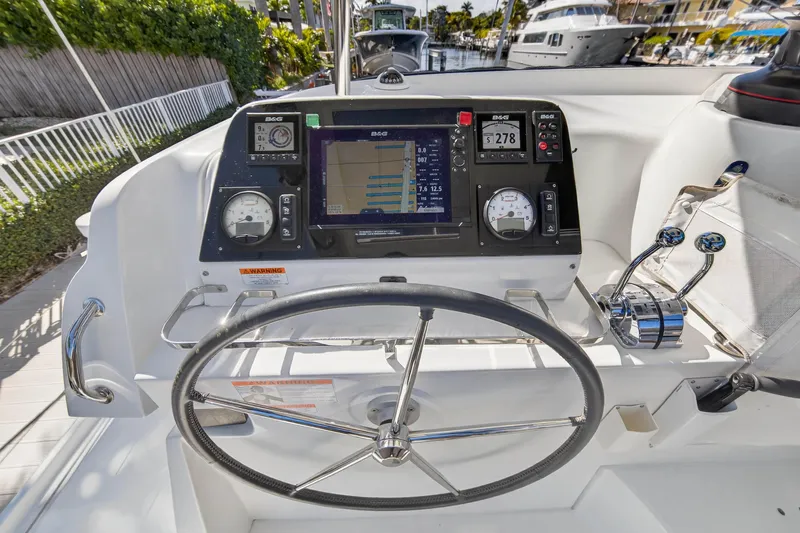 Slide: The Image of Cockpit of 2019 Lagoon 42 catamaran with navigation instruments and steering wheel. - 30