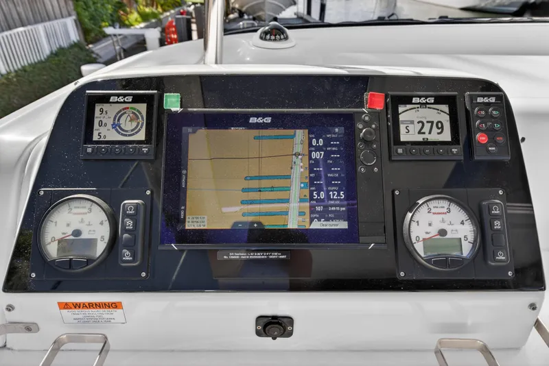 Slide: The Image of Control panel of a 2019 Lagoon 42 catamaran with navigation and engine displays. - 31