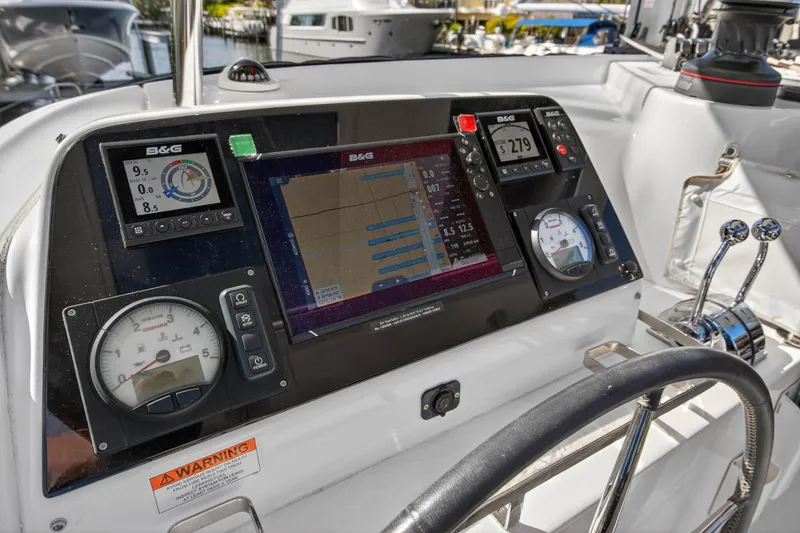 Slide: The Image of Cockpit of 2019 Lagoon 42 catamaran with navigation instruments and steering wheel. - 33