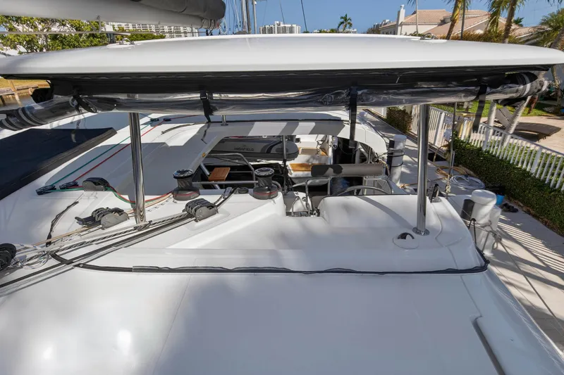 Slide: The Image of 2019 Lagoon 42 catamaran deck with rigging and equipment, docked in a sunny marina. - 39