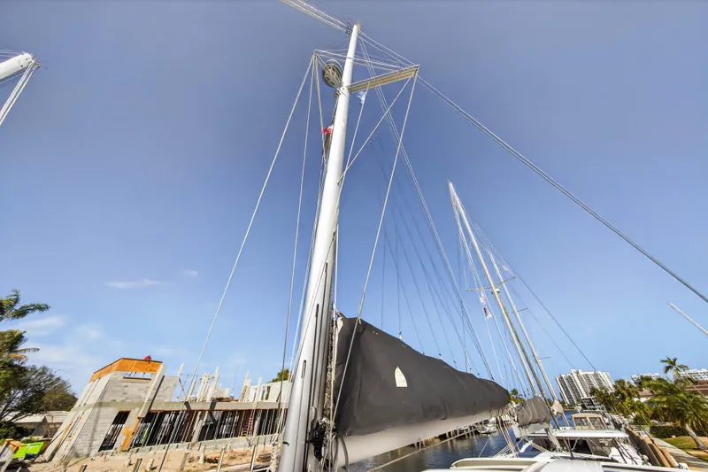 Slide: The Image of 2019 Lagoon 42 sailboat docked near construction site under clear blue sky. - 41