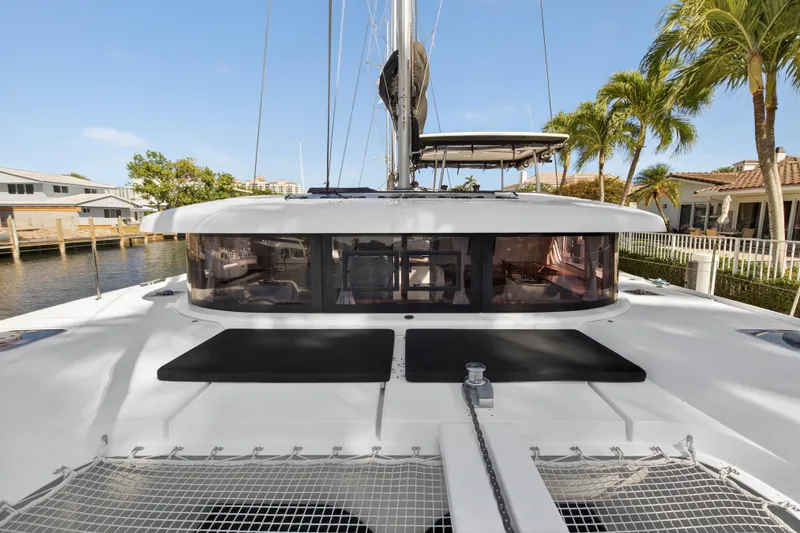 Slide: The Image of 2019 Lagoon 42 catamaran docked, featuring sleek design and spacious deck area. - 50