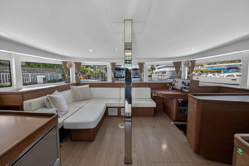 Slide: The Image of Luxurious interior of 2019 Lagoon 42 catamaran with modern seating and panoramic windows. - 55