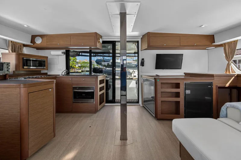 Slide: The Image of Interior of 2019 Lagoon 42 catamaran with modern kitchen and sleek wood finishes. - 58