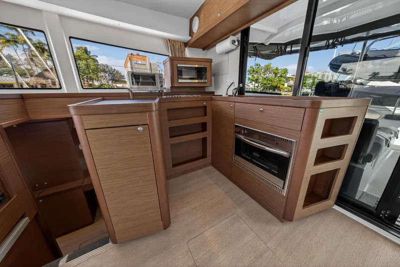 Slide: The Image of Modern kitchen interior of 2019 Lagoon 42 catamaran with wood finish and appliances. - 59