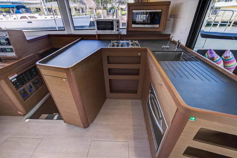 Slide: The Image of Modern kitchen interior of 2019 Lagoon 42 catamaran with wood finish and appliances. - 60