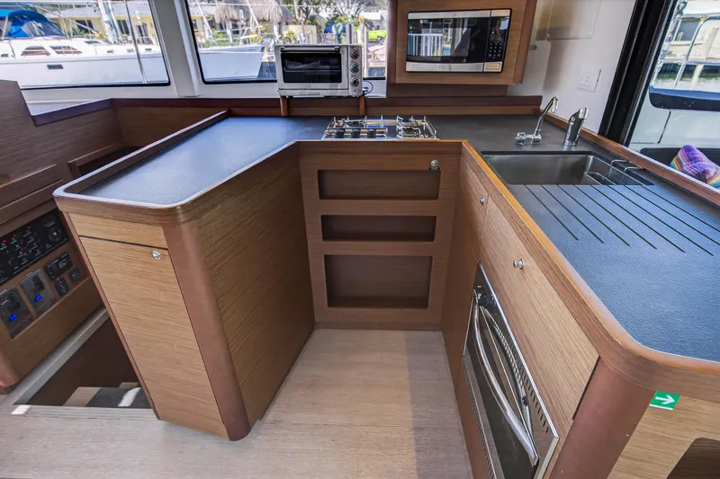 Slide: The Image of Modern kitchen interior of 2019 Lagoon 42 catamaran with wood finish and appliances. - 61
