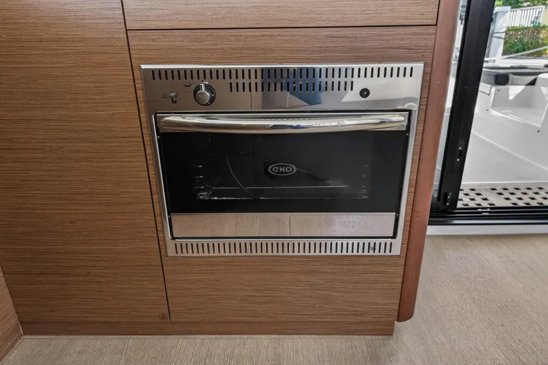 Slide: The Image of Built-in oven on Lagoon 42 yacht, 2019 model, with wooden cabinetry. - 63