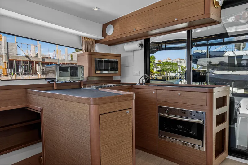 Slide: The Image of Modern kitchen interior of 2019 Lagoon 42 yacht with wood cabinetry and appliances. - 64