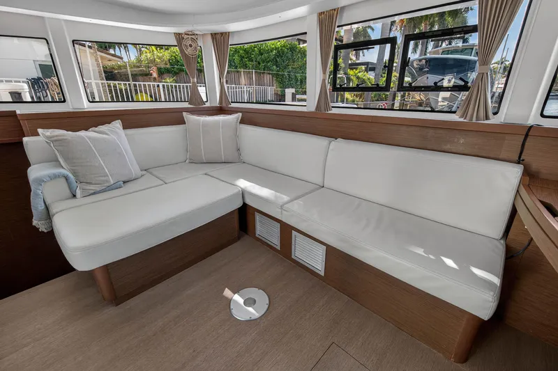 Slide: The Image of Luxurious interior of 2019 Lagoon 42 catamaran with white leather seating and large windows. - 66
