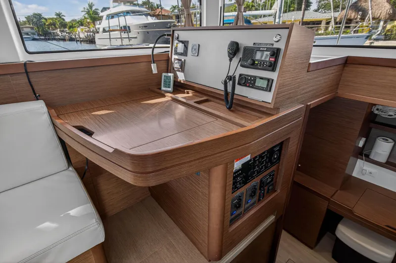 Slide: The Image of 2019 Lagoon 42 yacht interior with navigation controls and wooden finish. - 69