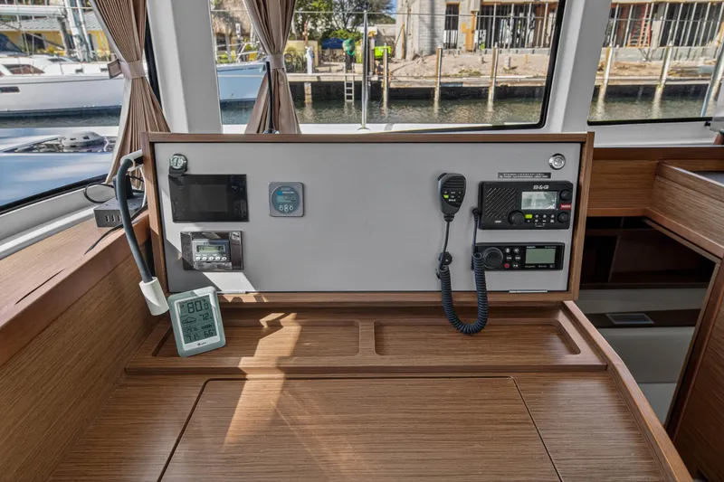 Slide: The Image of Interior view of 2019 Lagoon 42 yacht's navigation station with control panel and instruments. - 70