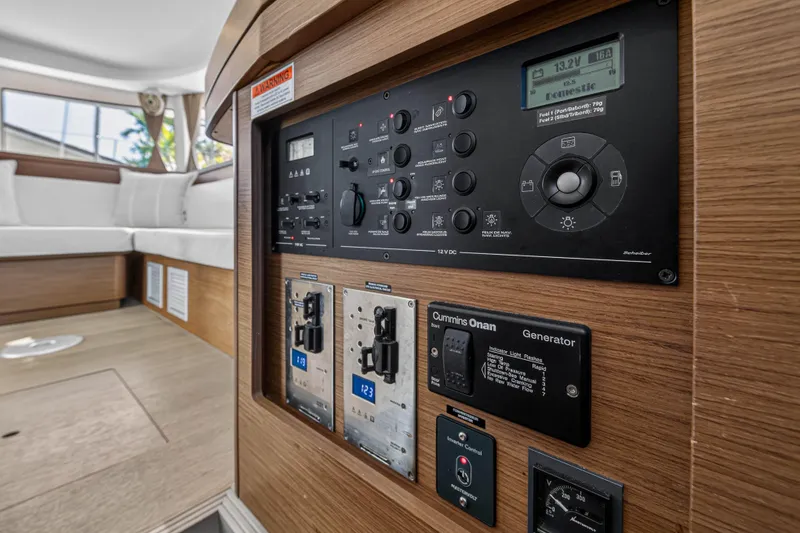 Slide: The Image of Control panel inside a 2019 Lagoon 42 catamaran, featuring generator and electrical system controls. - 71
