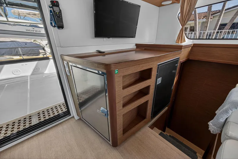 Slide: The Image of Interior of 2019 Lagoon 42 catamaran with wooden cabinetry and modern appliances. - 72