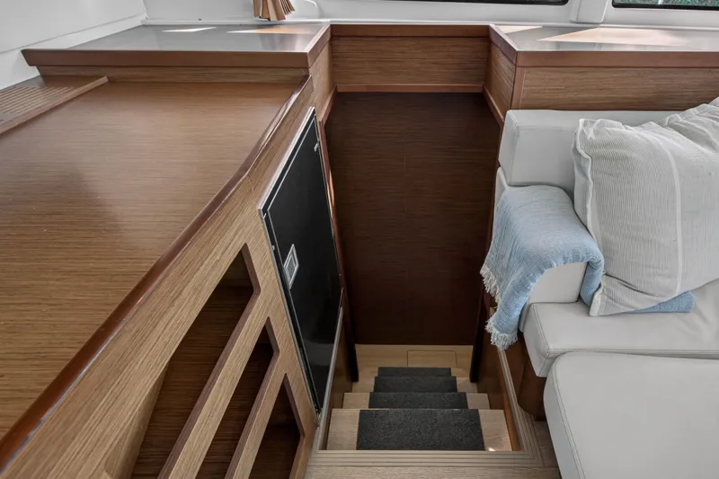 Slide: The Image of Interior of 2019 Lagoon 42 yacht with wooden stairs and cozy seating area. - 75