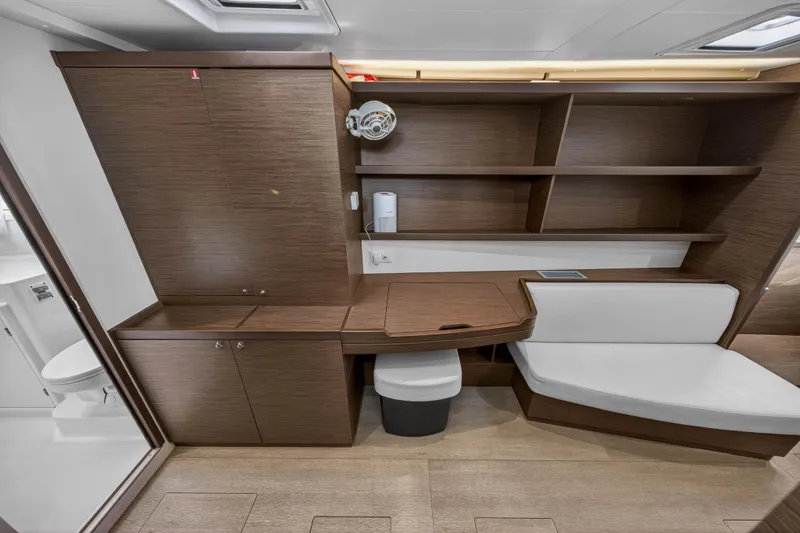 Slide: The Image of Interior of 2019 Lagoon 42 yacht with wooden cabinetry and seating area. - 76