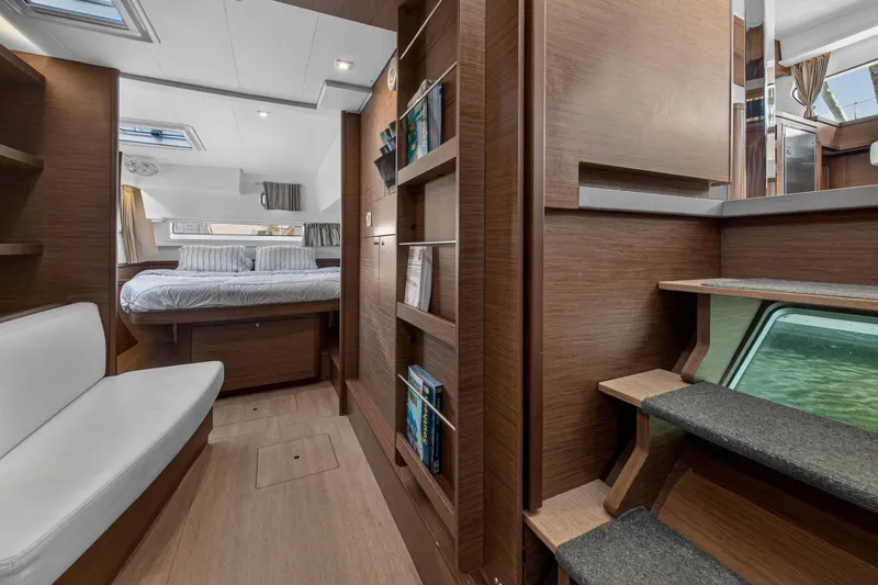 Slide: The Image of Interior of 2019 Lagoon 42 catamaran featuring cozy bedroom and modern wooden design. - 77