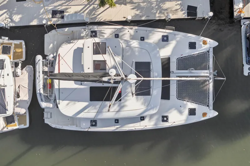 Slide: The Image of Overhead view of a 2019 Lagoon 42 catamaran docked at a marina. - 8