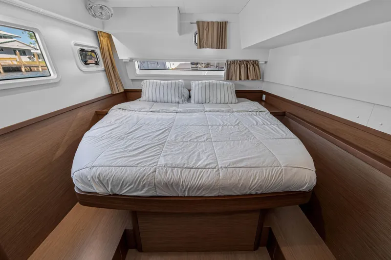 Slide: The Image of Luxurious cabin interior of 2019 Lagoon 42 catamaran with cozy bed and wooden accents. - 80