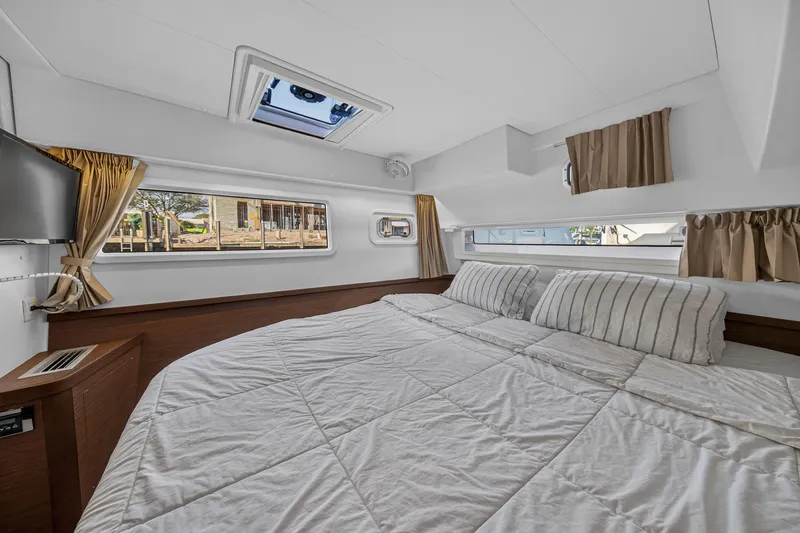 Slide: The Image of Luxurious cabin interior of 2019 Lagoon 42 catamaran with cozy bedding and natural light. - 81