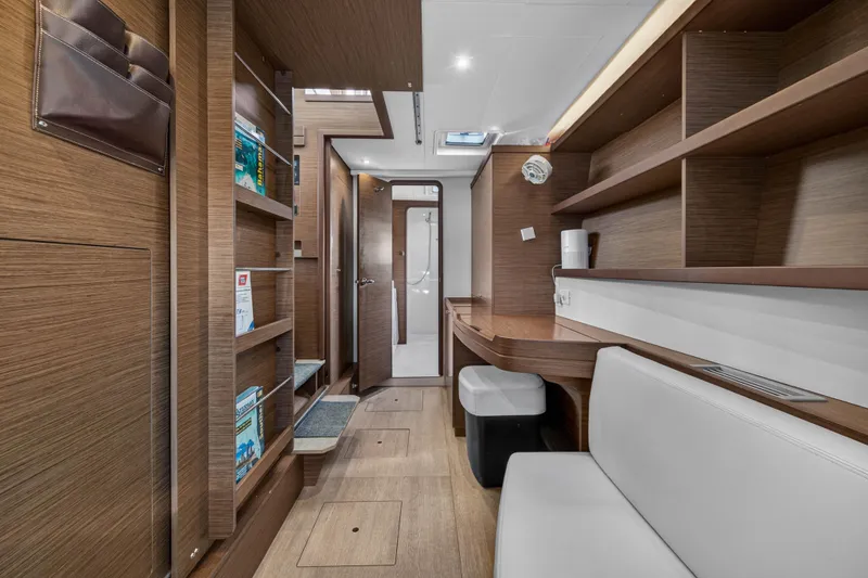 Slide: The Image of Interior of 2019 Lagoon 42 yacht with wooden shelves and seating area. - 83