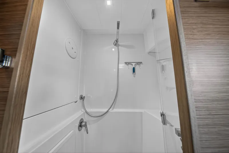 Slide: The Image of Modern shower area in 2019 Lagoon 42 catamaran, featuring sleek fixtures and white interior. - 88