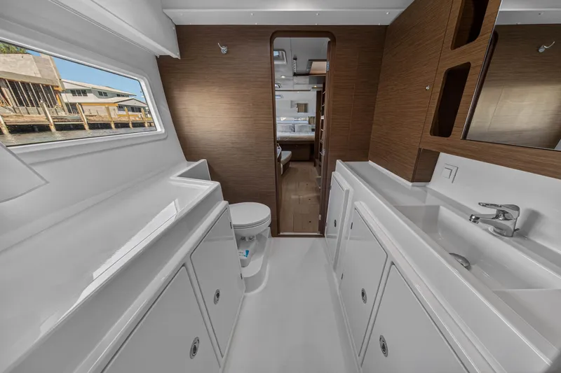 Slide: The Image of Interior of 2019 Lagoon 42 catamaran bathroom with modern fixtures and wood accents. - 90