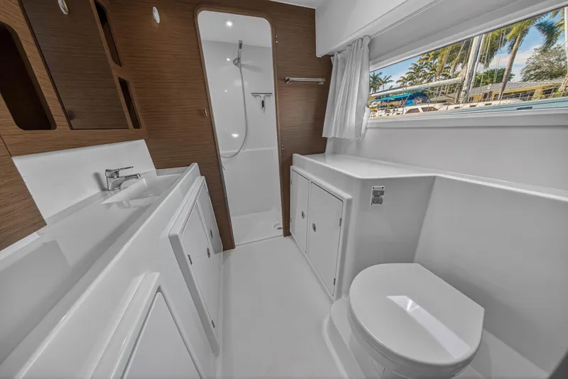 Slide: The Image of Luxurious bathroom interior of 2019 Lagoon 42 yacht with modern fixtures and wood accents. - 91
