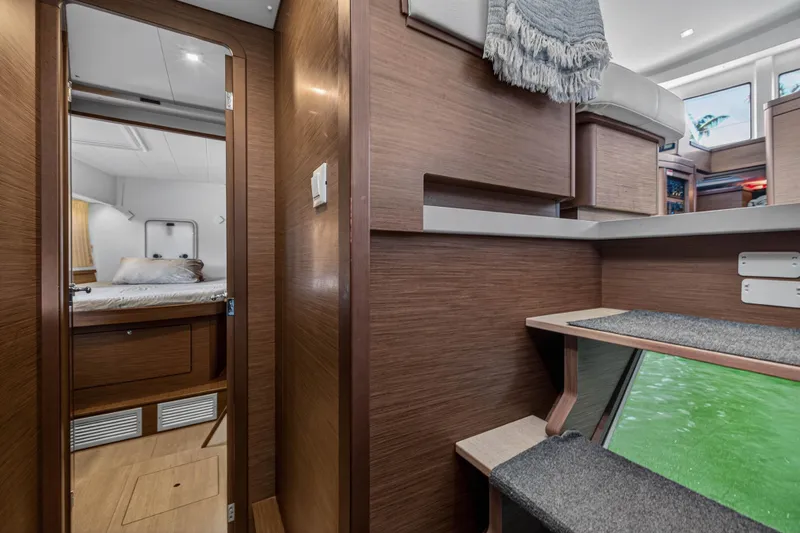 Slide: The Image of Interior of 2019 Lagoon 42 catamaran, featuring cozy cabin and modern wooden finishes. - 98