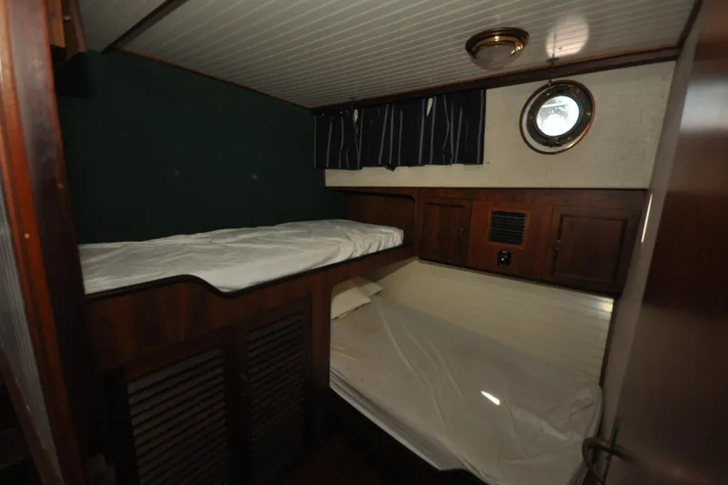 Slide: The Image of Cozy cabin interior of 1982 Custom Virpack Steelhull with bunk beds and porthole. - 13