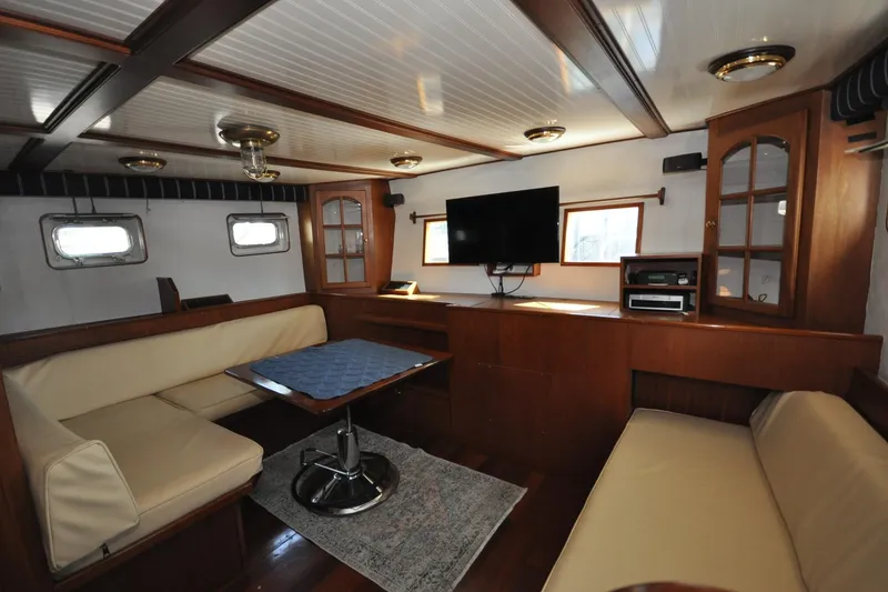Slide: The Image of Interior of 1982 Custom Virpack Steelhull yacht with cozy seating and modern amenities. - 15