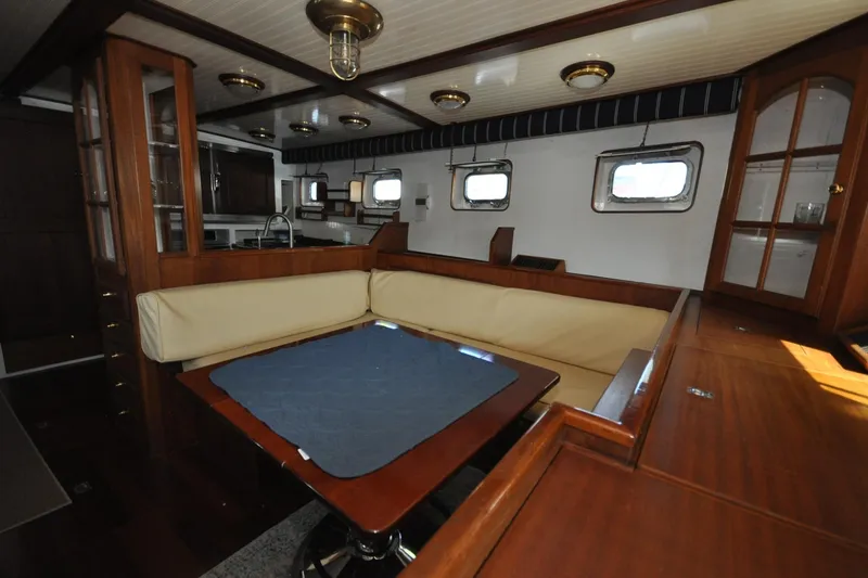 Slide: The Image of Interior of 1982 Custom Virpack Steelhull yacht with wooden furnishings and cozy seating area. - 16