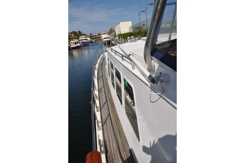 Slide: The Image of Custom 1982 Virpack Steelhull yacht docked in a serene marina setting. - 26