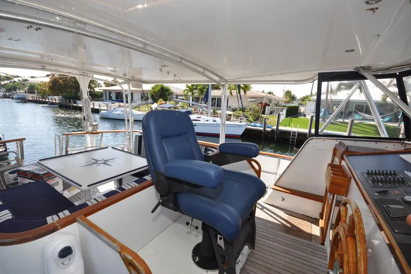 Slide: The Image of Luxurious 1982 Custom Virpack Steelhull yacht interior with blue captain's chair and waterfront view. - 3