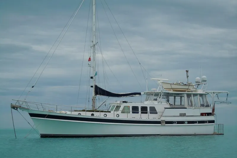Slide: The Image of Custom 1982 Virpack Steelhull yacht anchored on calm turquoise waters. - 34