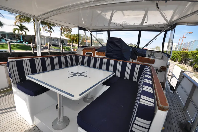 Slide: The Image of 1982 Custom Virpack Steelhull boat interior with striped seating and nautical-themed table. - 4