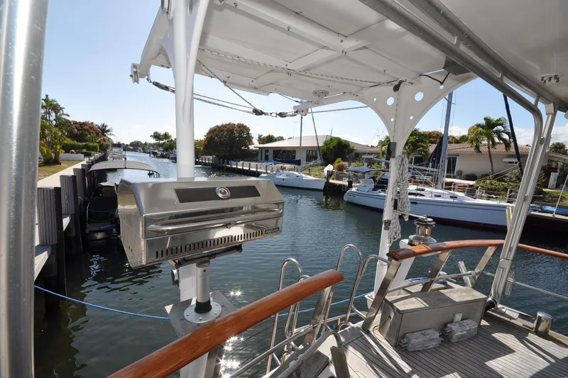 Slide: The Image of Custom 1982 Virpack Steelhull boat with grill, docked in a scenic canal setting. - 5