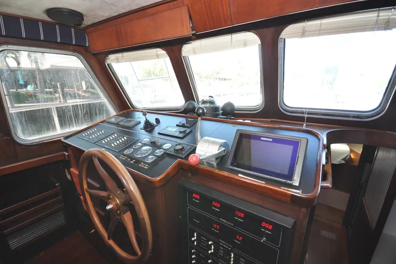 Slide: The Image of Interior helm of 1982 Custom Virpack Steelhull boat with navigation controls and wooden steering wheel. - 6