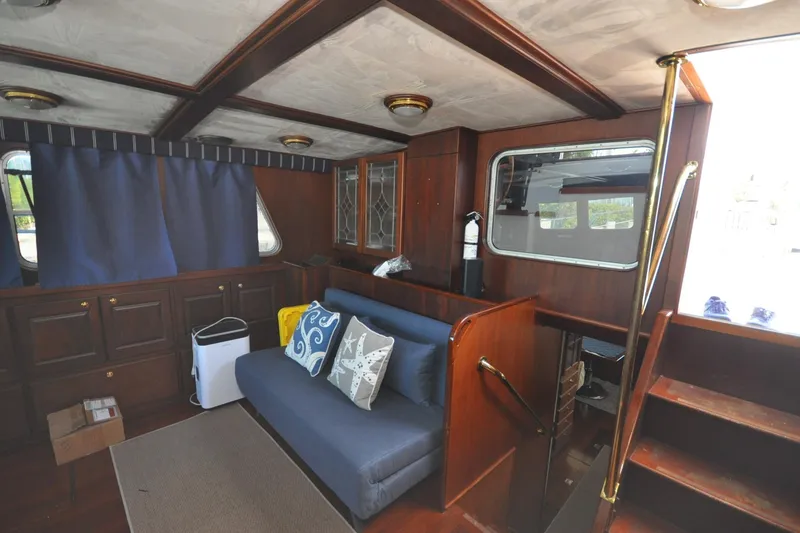 Slide: The Image of Interior of 1982 Custom Virpack Steelhull boat with wooden furnishings and blue sofa. - 7