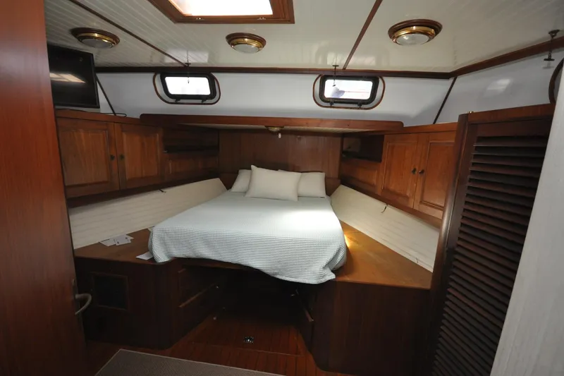 Slide: The Image of Cozy cabin interior of 1982 Custom Virpack Steelhull with wooden furnishings and bed. - 8