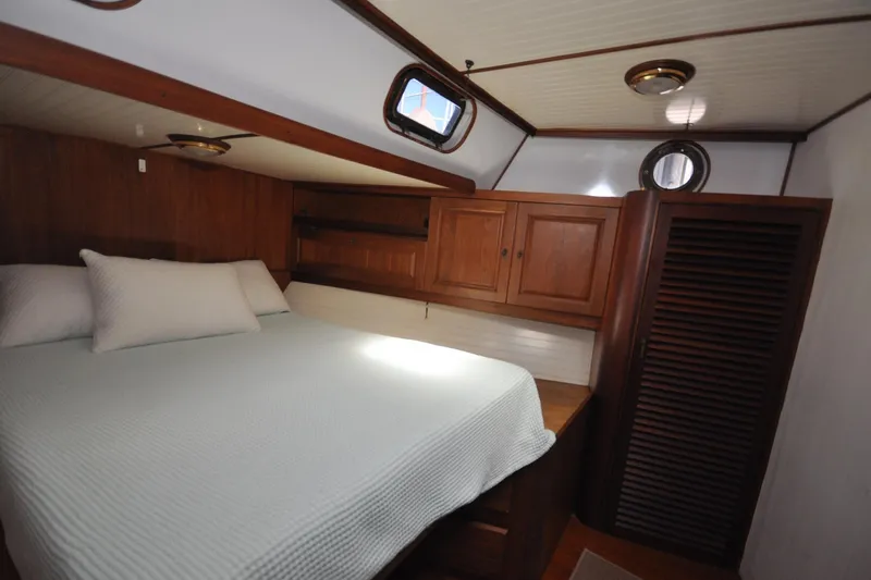 Slide: The Image of Cozy cabin interior of 1982 Custom Virpack Steelhull with wooden furnishings and porthole windows. - 9