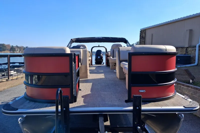 Slide: The Image of 2026 Bentley Pontoons Legacy 240 Navigator, docked, showcasing spacious seating and modern design. - 2